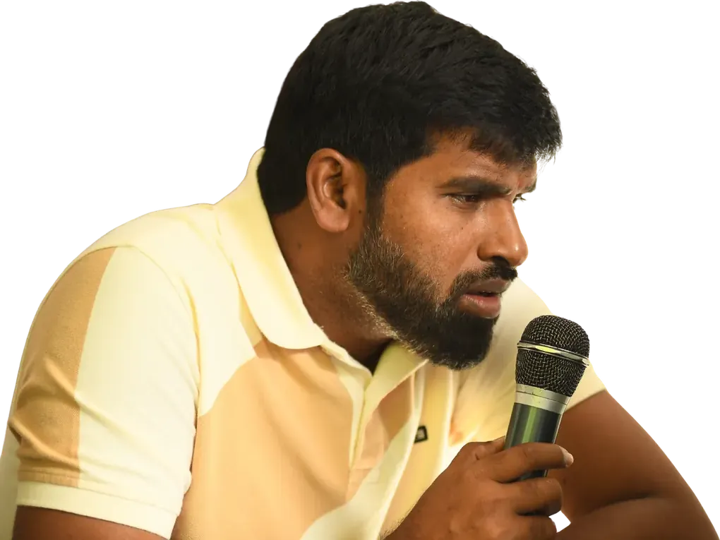 Jai Jnana Prabha Thota speaking into a microphone at a press event