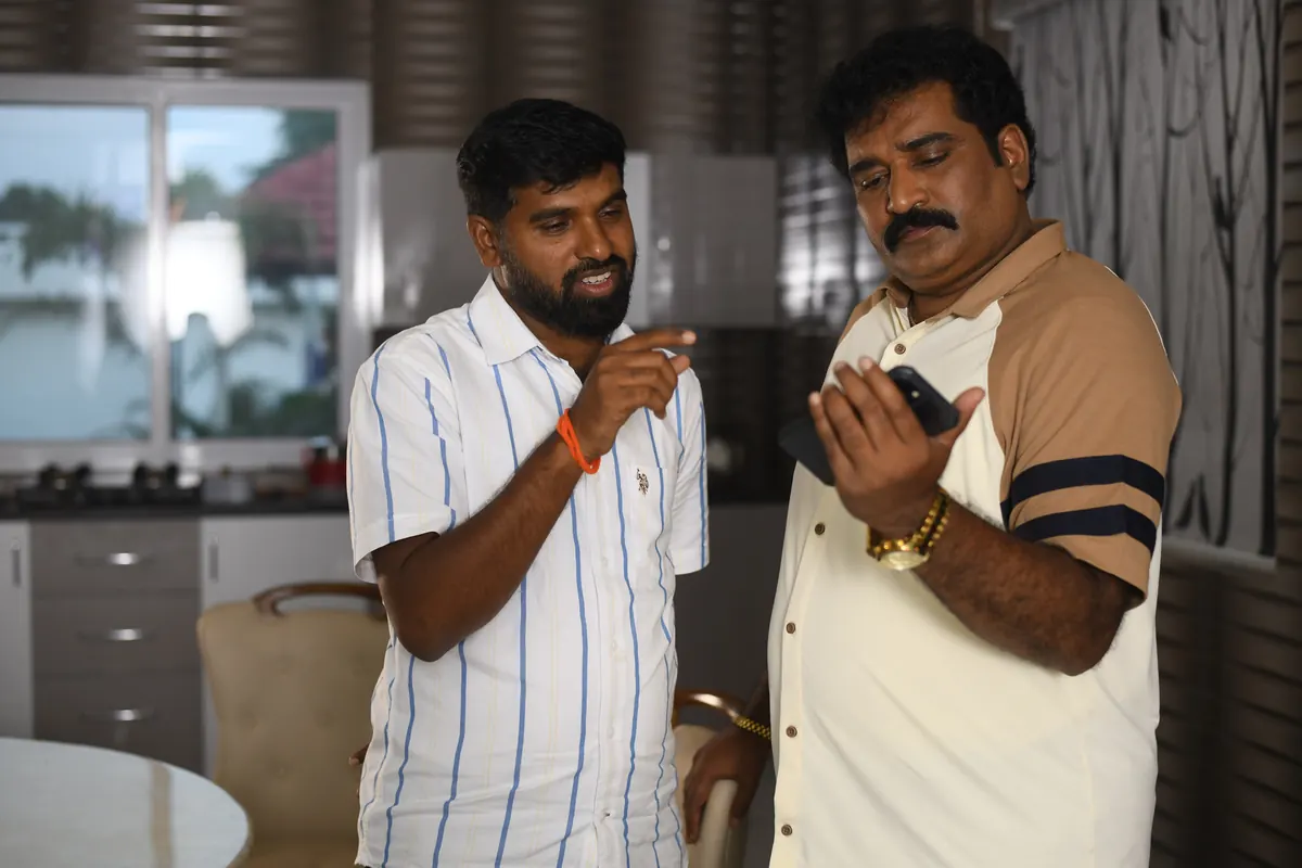 Jai Jnana Prabha Thota reviewing a shot with a team member